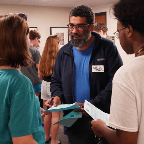 Samir Iqbal, associate dean and professor of computing, chats with students at the College of Computing welcome event.